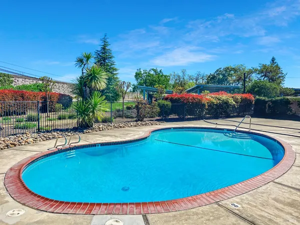 a view of a swimming pool with an outdoor space and seating area