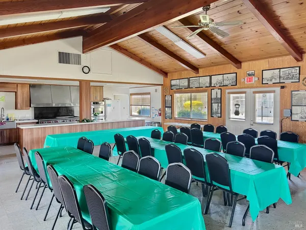a room with lots of chairs and a dining table with chairs