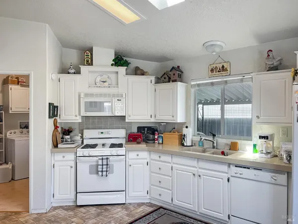 a kitchen with cabinets appliances cabinets and a sink
