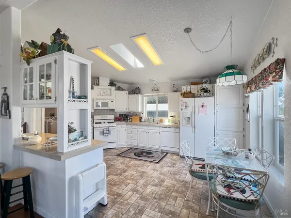 a kitchen with refrigerator and cabinets