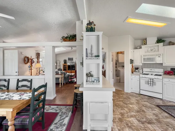a kitchen with stainless steel appliances kitchen island granite countertop a refrigerator and a stove top oven