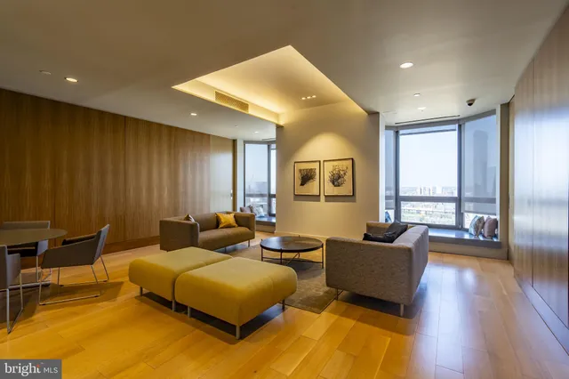 a bedroom with furniture and a large window