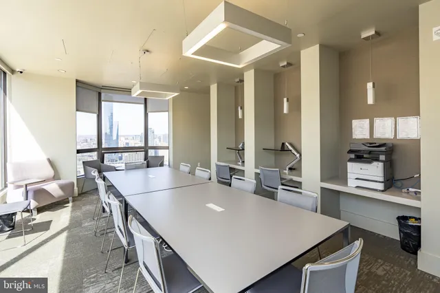 a large kitchen with kitchen island a large island in it