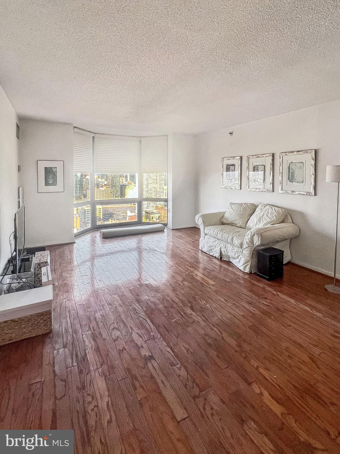 2020 Walnut Street, Unit 29K Philadelphia, PA 19103 - Photo 2 of 20 a living room with furniture and a wooden floor