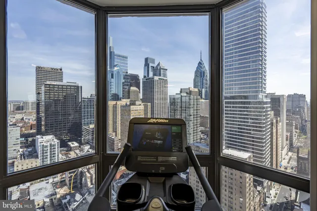 a view of a balcony with chairs and a gate