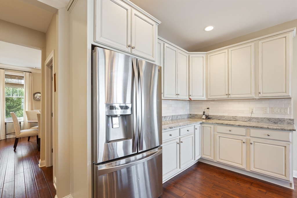 151 HMS Halsted Drive, Unit 151 Hingham, MA 02043 - Photo 23 of 41 a kitchen with cabinets stainless steel appliances and wooden floor