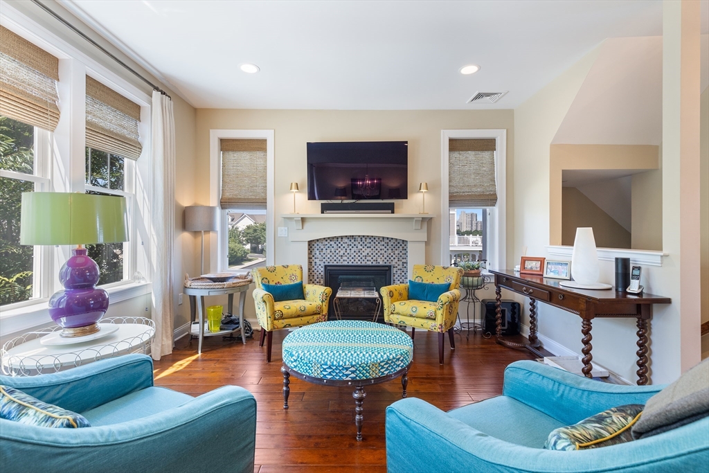 151 HMS Halsted Drive, Unit 151 Hingham, MA 02043 - Photo 25 of 41 a living room with furniture a flat screen tv and a fireplace