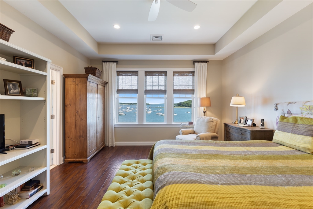 151 HMS Halsted Drive, Unit 151 Hingham, MA 02043 - Photo 28 of 41 a bedroom with a bed and a large window