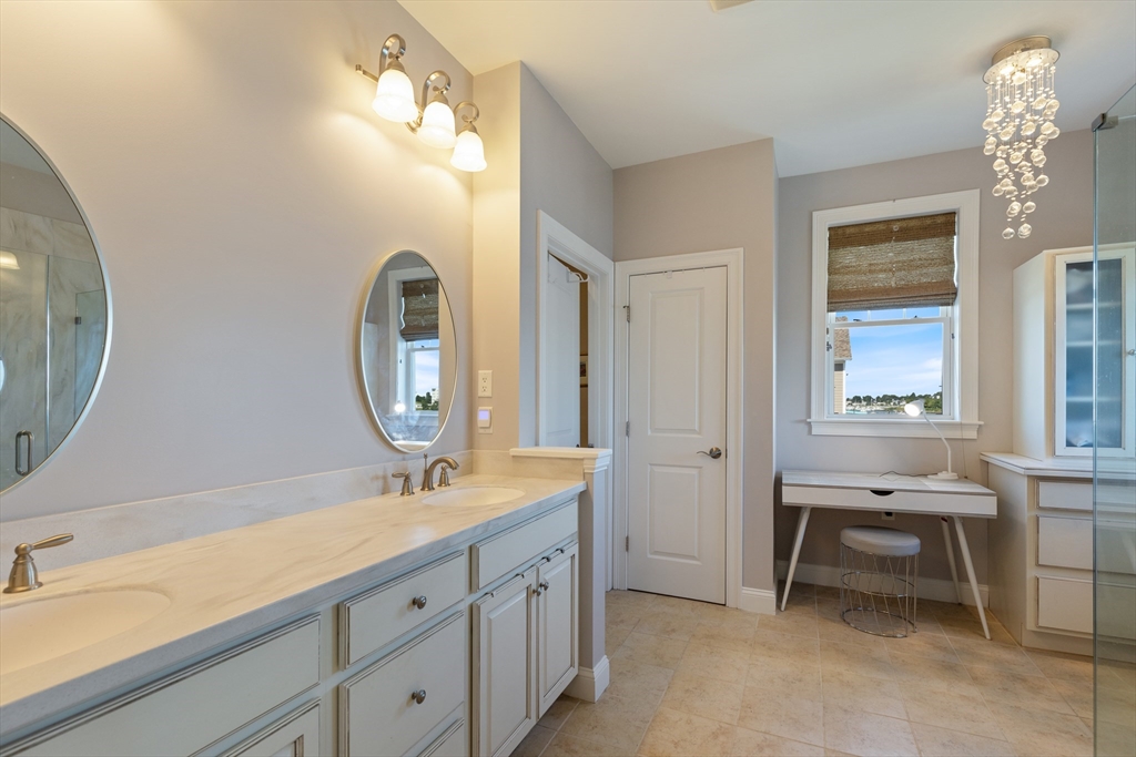151 HMS Halsted Drive, Unit 151 Hingham, MA 02043 - Photo 30 of 41 a bathroom with a double vanity sink and a mirror