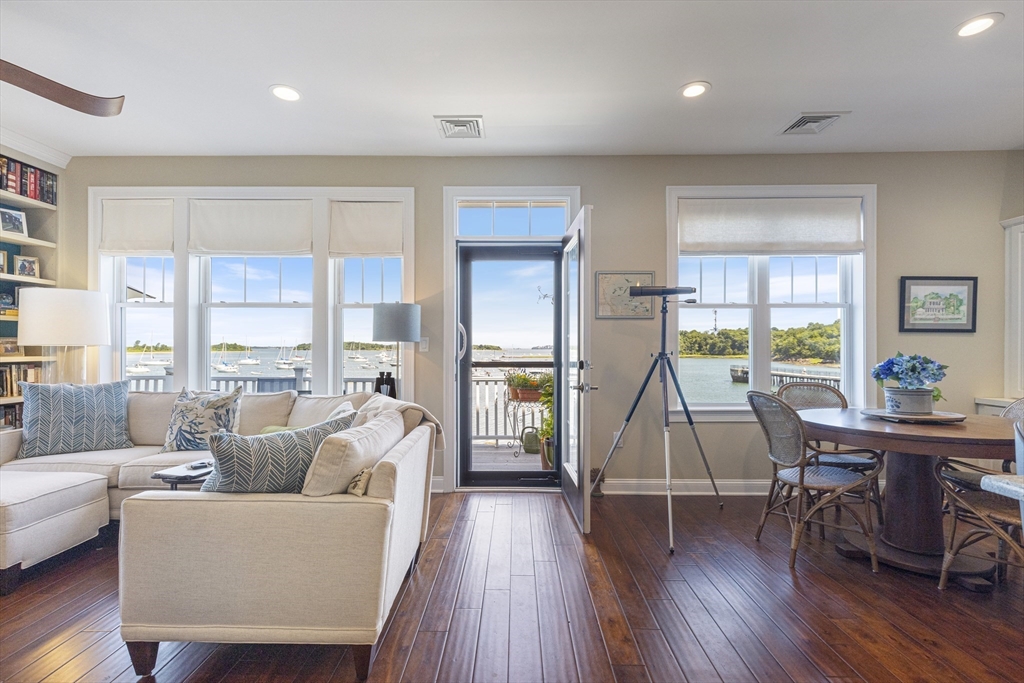 151 HMS Halsted Drive, Unit 151 Hingham, MA 02043 - Photo 3 of 41 a living room with furniture a wooden floor and a large window