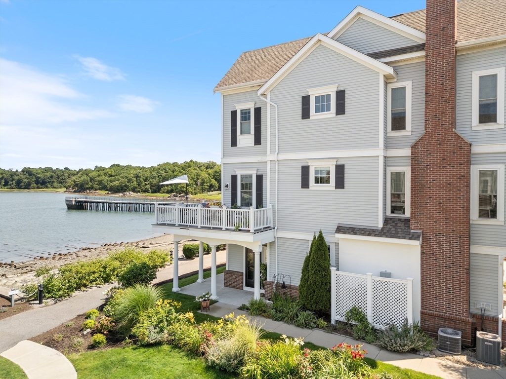 151 HMS Halsted Drive, Unit 151 Hingham, MA 02043 - Photo 5 of 41 a front view of a house with a yard and potted plants