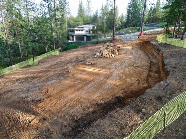 an aerial view of residential houses with outdoor space and river