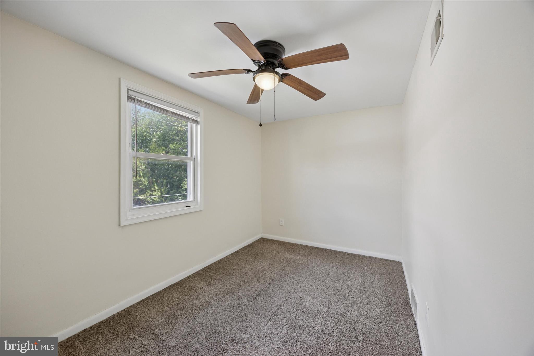 723 Bennington Road Folcroft, PA 19032 - Photo 13 of 25 an empty room with ceiling fan and window