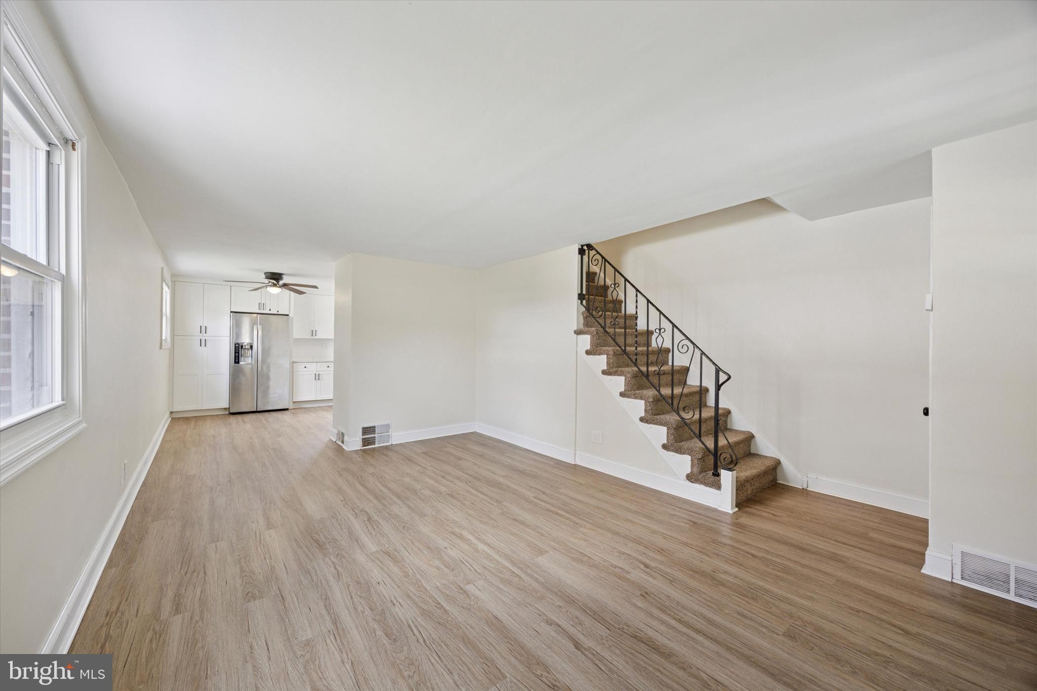 723 Bennington Road Folcroft, PA 19032 - Photo 3 of 25 a view of an empty room with wooden floor and stairs