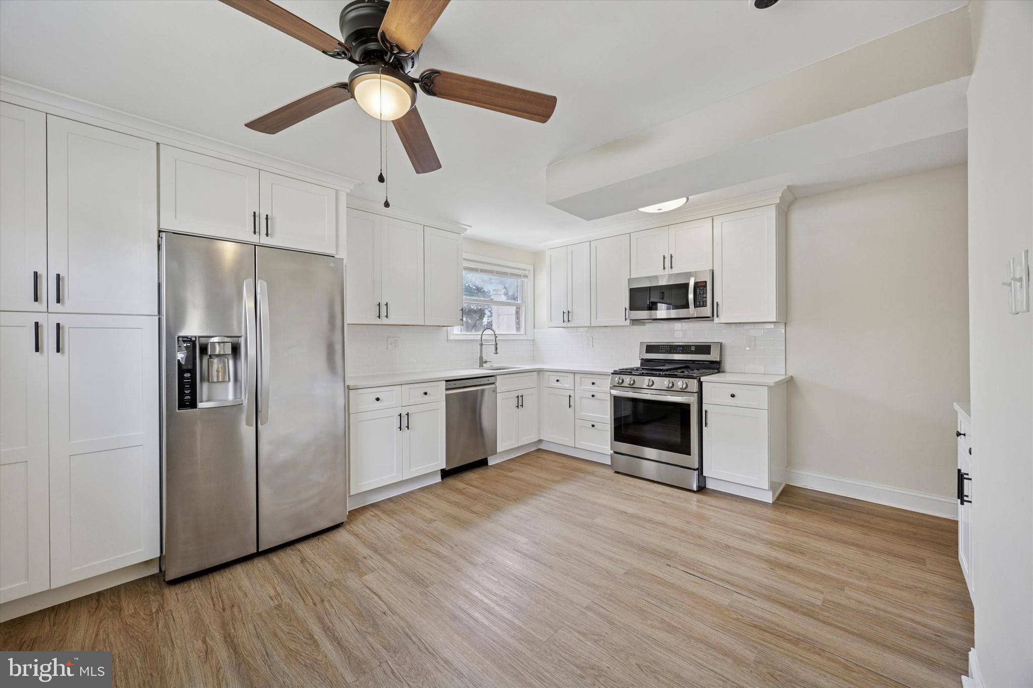 723 Bennington Road Folcroft, PA 19032 - Photo 7 of 25 a kitchen with stainless steel appliances a refrigerator sink and microwave