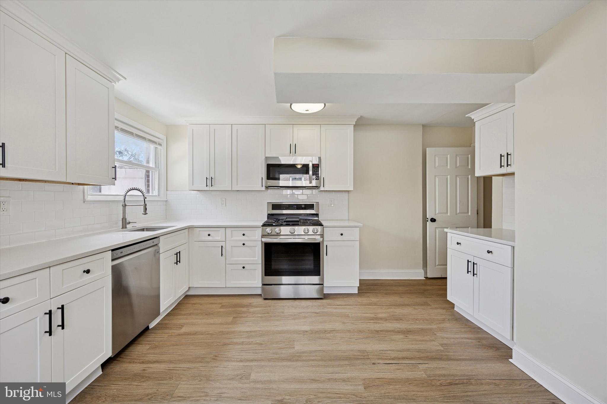 723 Bennington Road Folcroft, PA 19032 - Photo 10 of 25 a kitchen with granite countertop a stove top oven and cabinets