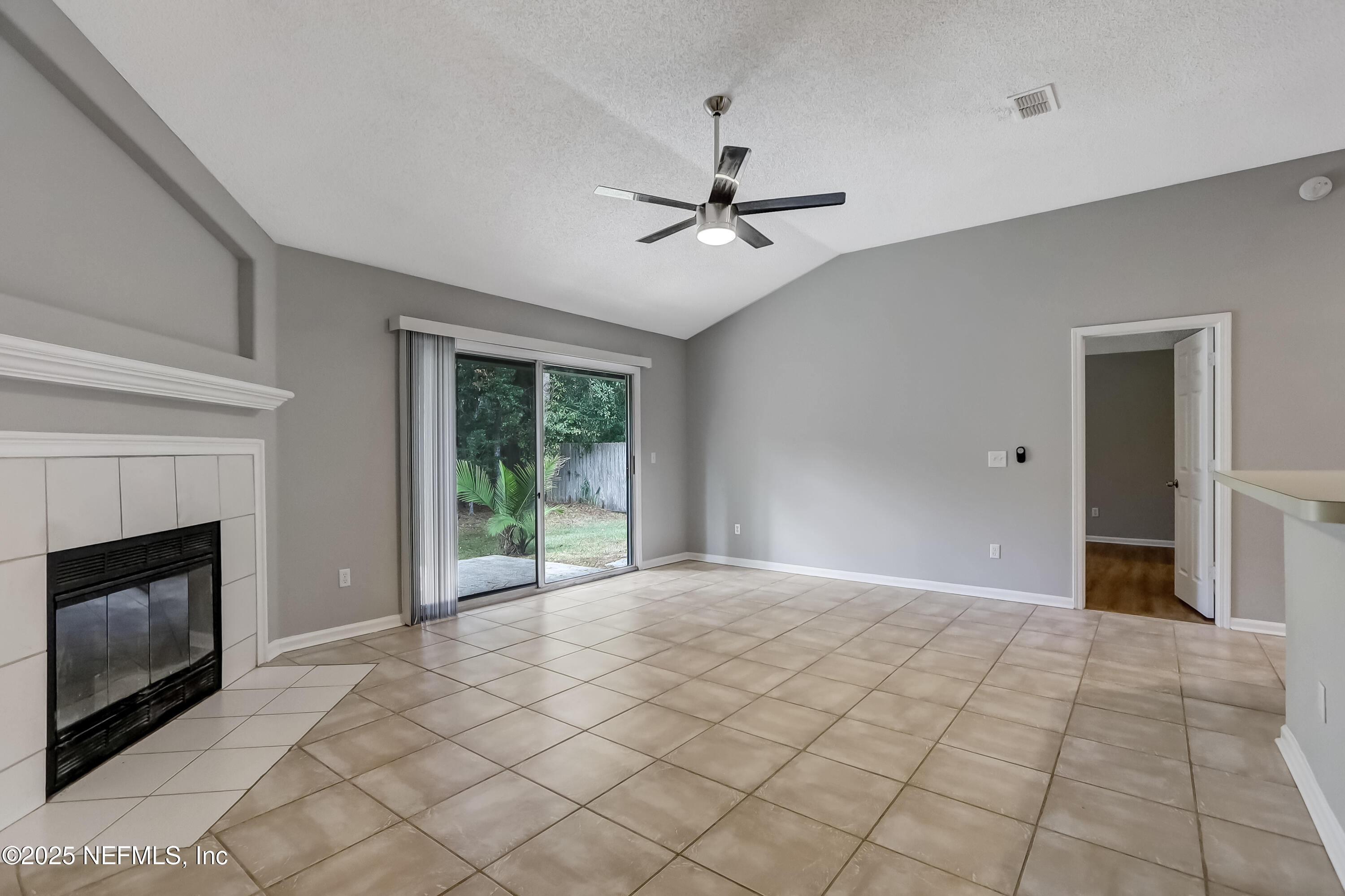 9642 Pritmore Road East Jacksonville, FL 32257 - Photo 1 of 47 a view of empty room with window and fireplace