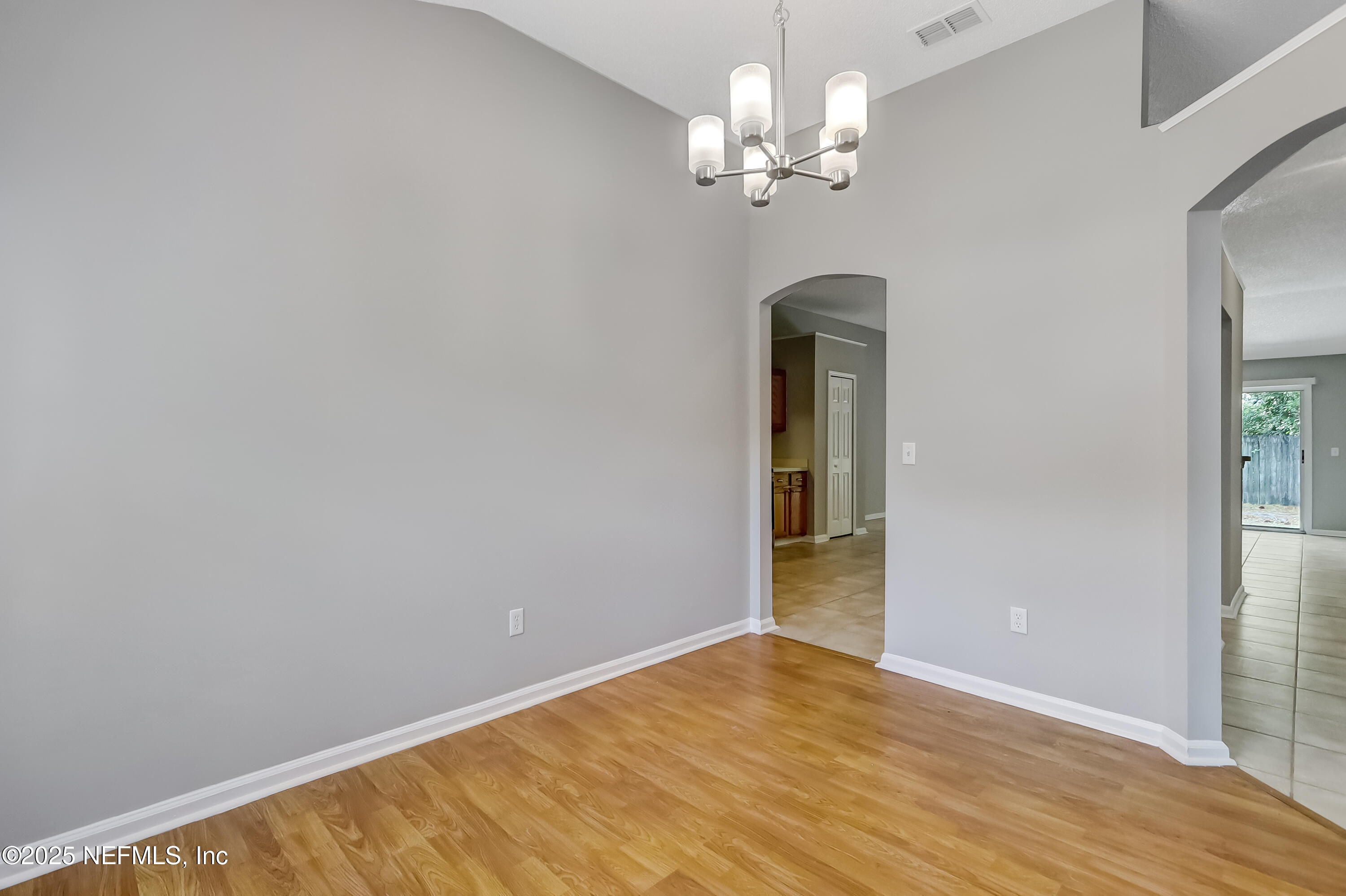 9642 Pritmore Road East Jacksonville, FL 32257 - Photo 15 of 47 a view of an empty room with wooden floor and a window