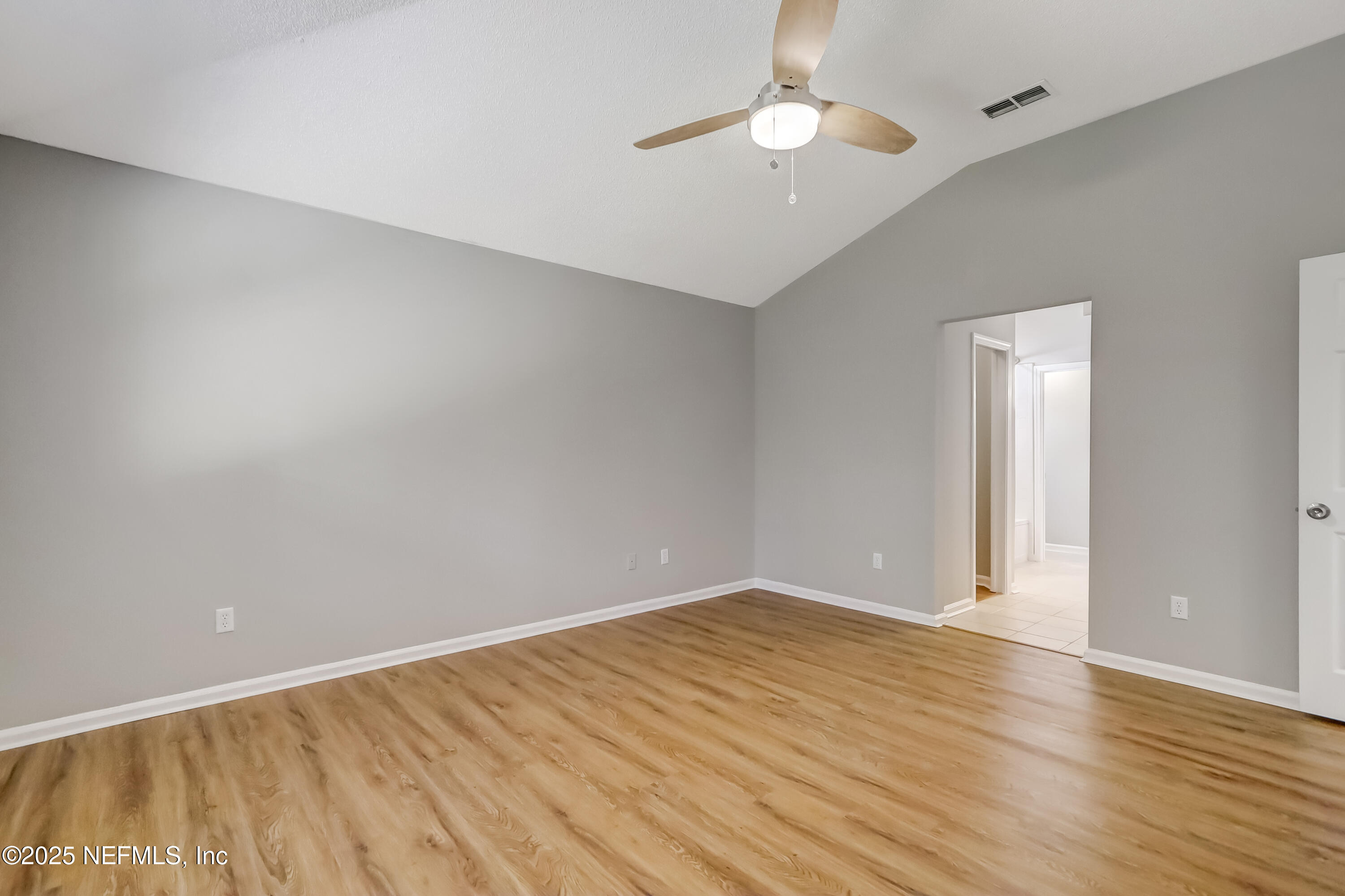 9642 Pritmore Road East Jacksonville, FL 32257 - Photo 31 of 47 an empty room with wooden floor and windows