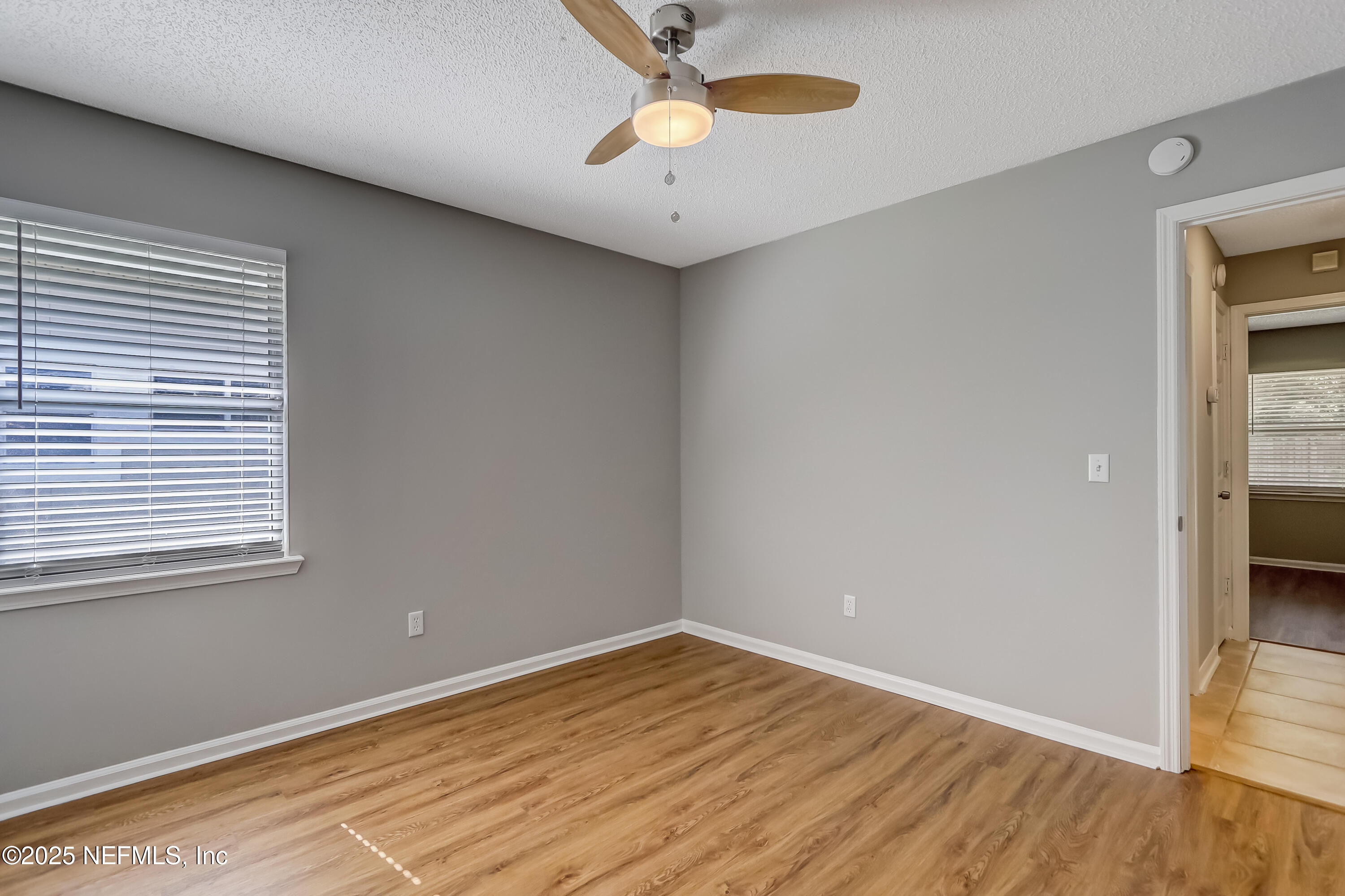 9642 Pritmore Road East Jacksonville, FL 32257 - Photo 32 of 47 a view of empty room with wooden floor and fan