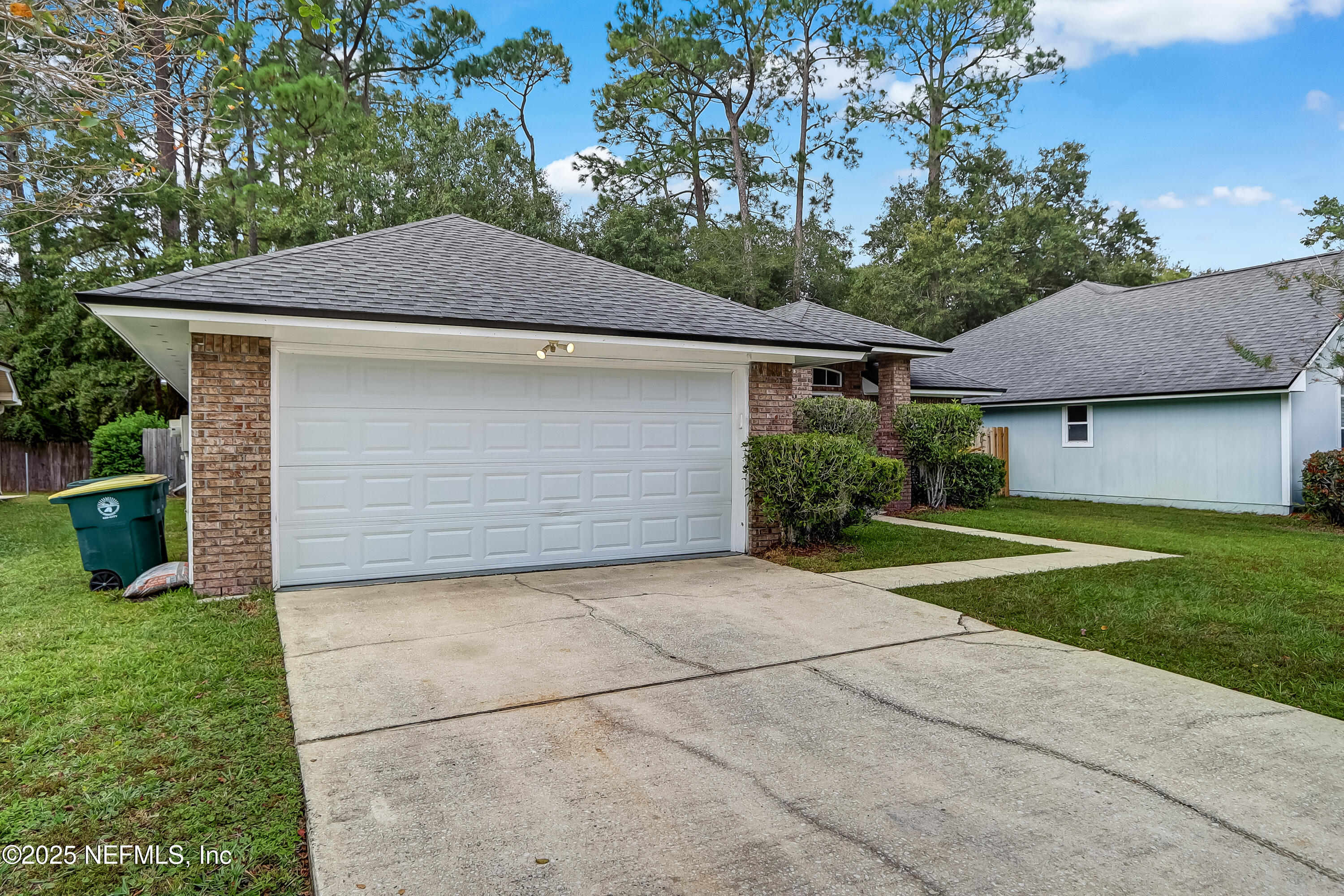 9642 Pritmore Road East Jacksonville, FL 32257 - Photo 6 of 47 a front view of a house with a yard and garage