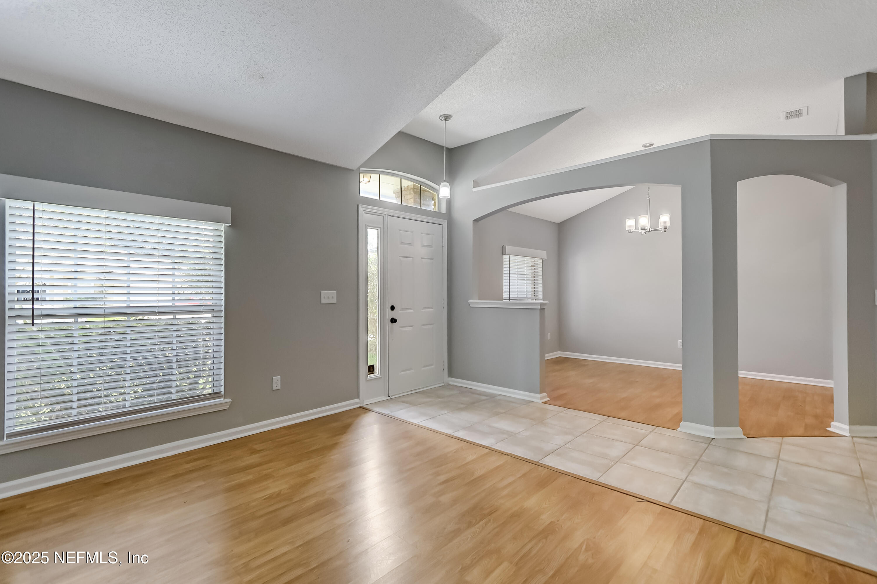 9642 Pritmore Road East Jacksonville, FL 32257 - Photo 9 of 47 a view of an empty room with wooden floor and a window