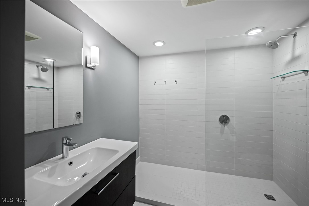 2711 Glenmont Road Northwest Canton, OH 44708 - Photo 34 of 42 Full bath featuring a tile shower, vanity, and recessed lighting