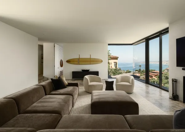 a living room with furniture a large window and a fireplace