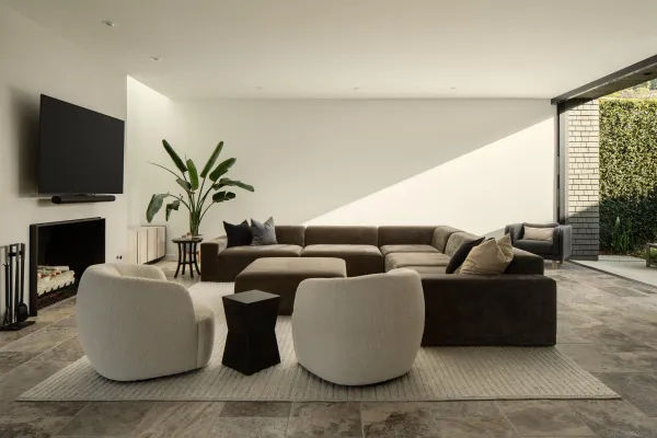 a living room with furniture and a floor to ceiling window