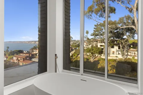 a view of a patio with a table and chairs under an umbrella