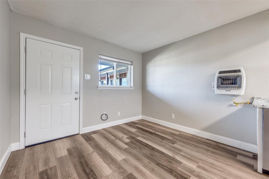1001 West Elm Street, Unit 201 Denison, TX 75020 - Photo 12 of 12 a view of empty room with wooden floor and fan