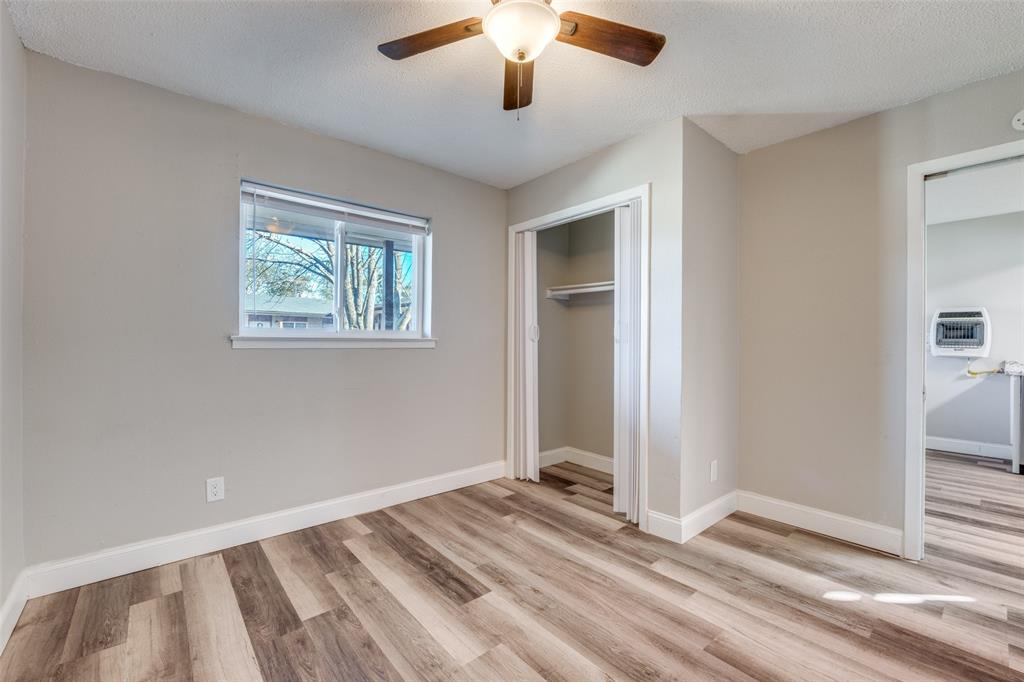 1001 West Elm Street, Unit 201 Denison, TX 75020 - Photo 5 of 12 a view of a livingroom with a chandelier fan and windows