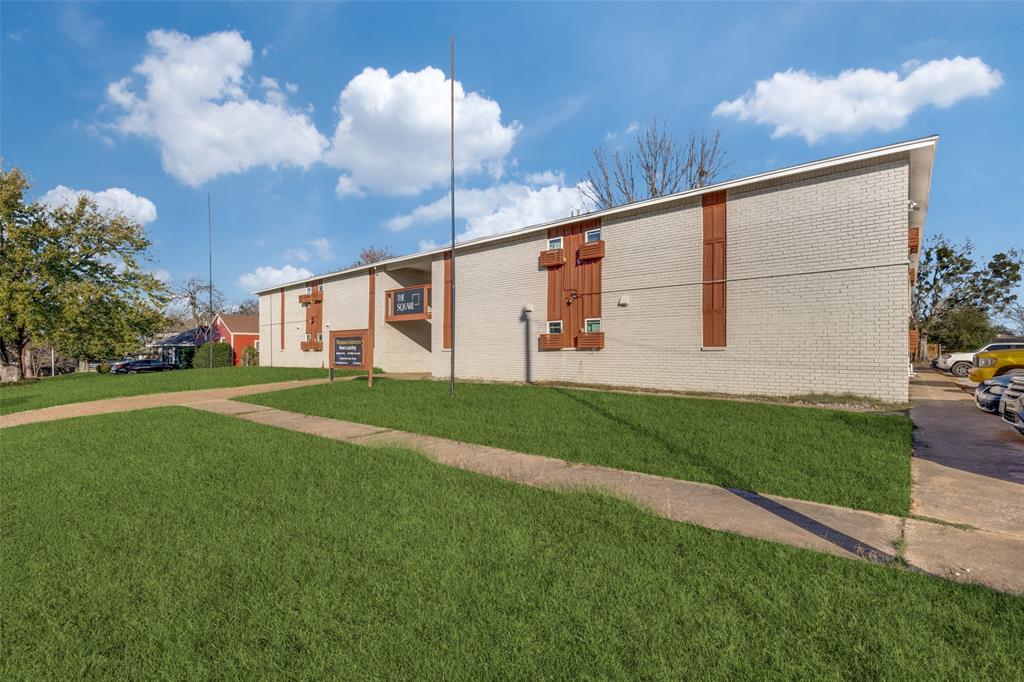 1001 West Elm Street, Unit 201 Denison, TX 75020 - Photo 9 of 12 a front view of a house with garden