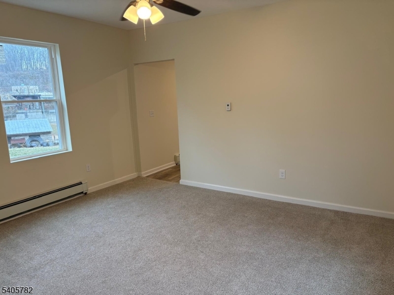 786 South Main Street, Unit 1 Phillipsburg, NJ 08865 - Photo 6 of 18 an empty room with a chandelier fan