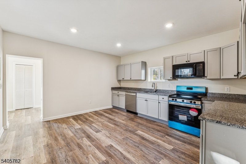 786 South Main Street, Unit 1 Phillipsburg, NJ 08865 - Photo 9 of 18 a kitchen with granite countertop white cabinets and stainless steel appliances