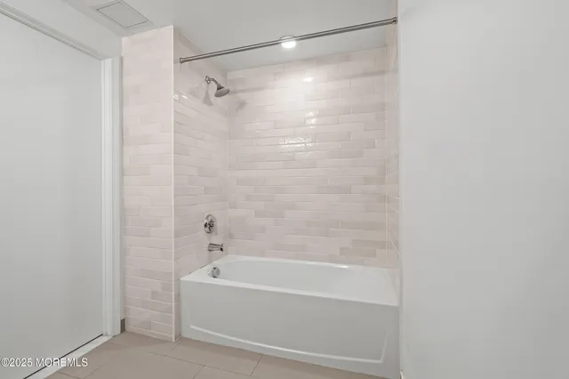 a bathroom with a shower and a bath tub