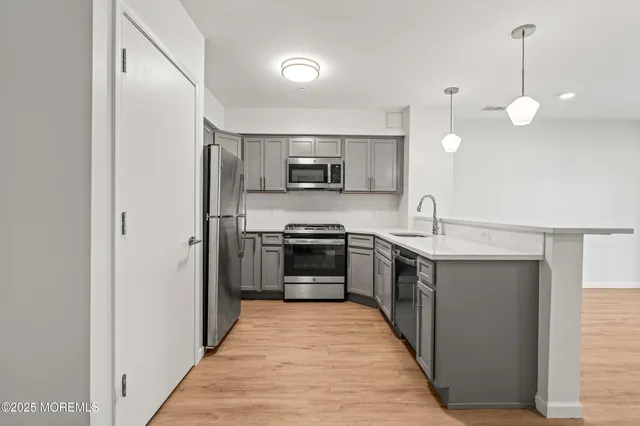 a large kitchen with a stove and a sink