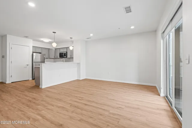 a view of a kitchen with a sink and a refrigerator
