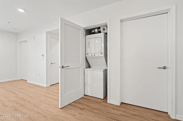a view of hallway with wooden floor