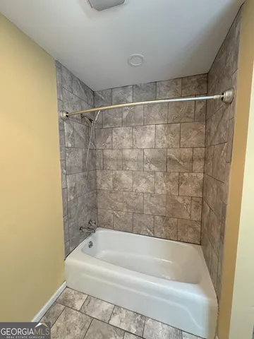 a bathroom with a sink a toilet a mirror and shower