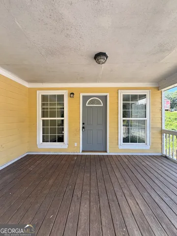 a view of a house with wooden floor and windows