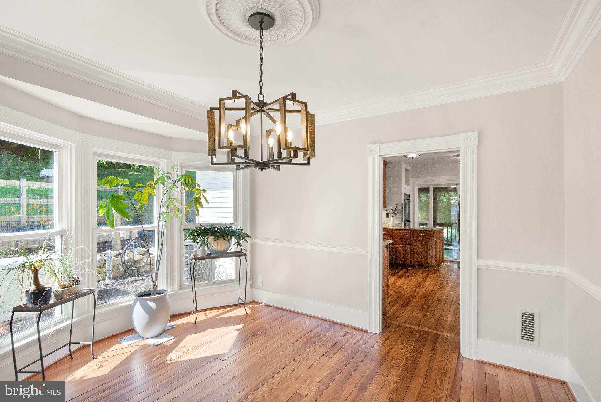 37151 Branchriver Road Purcellville, VA 20132 - Photo 11 of 63 a view of a room with wooden floor windows and a chandelier
