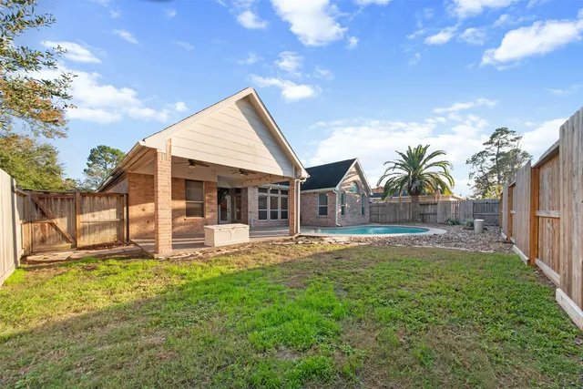 a view of a house with a yard and sitting area