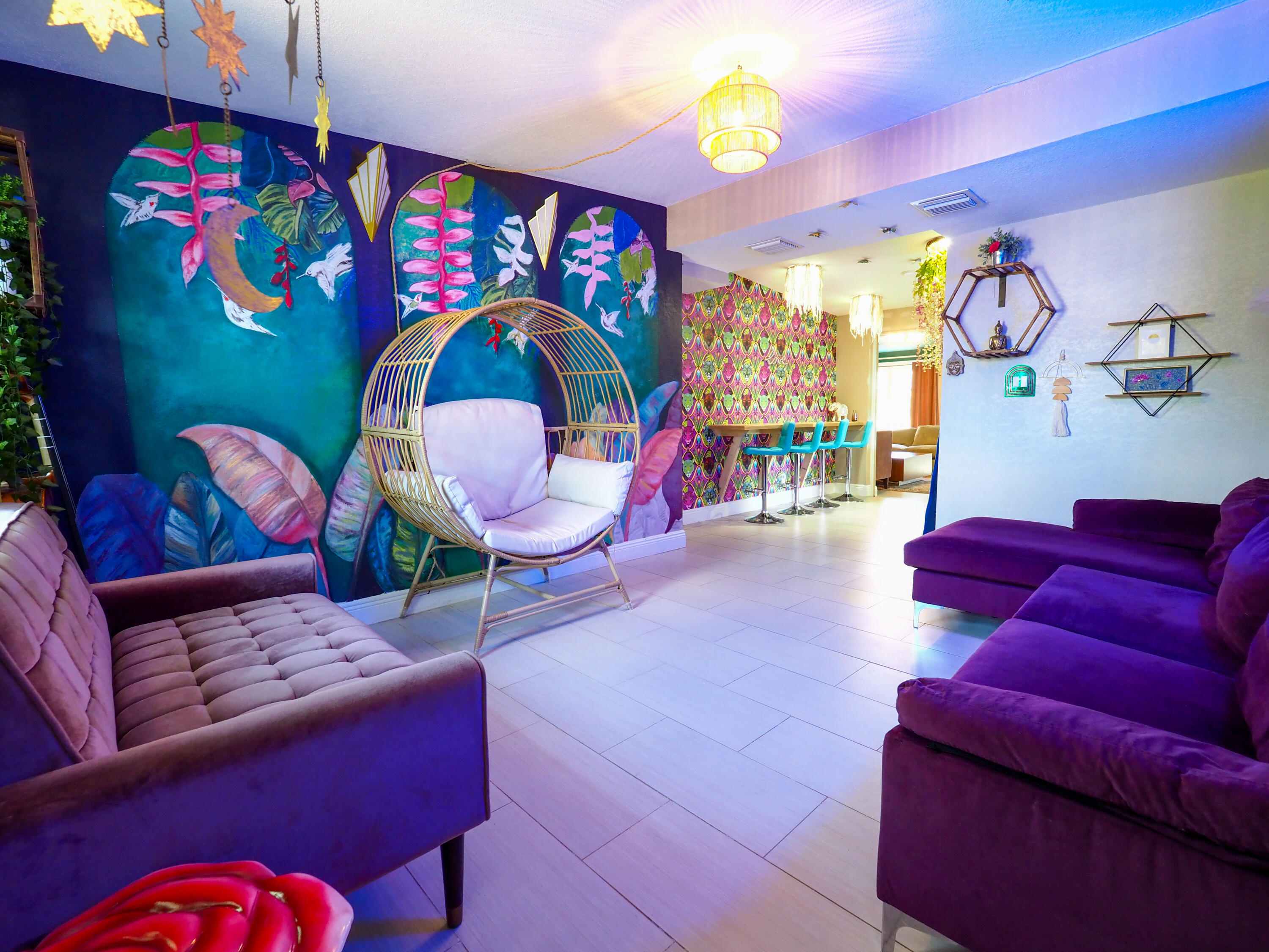 a living room with furniture a rug and a wall painting