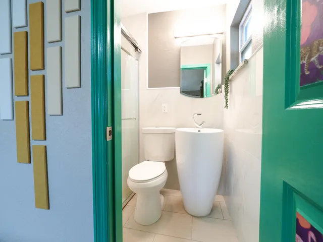 a bathroom with a toilet a sink and shower