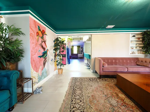 a living room with furniture plant and a large window