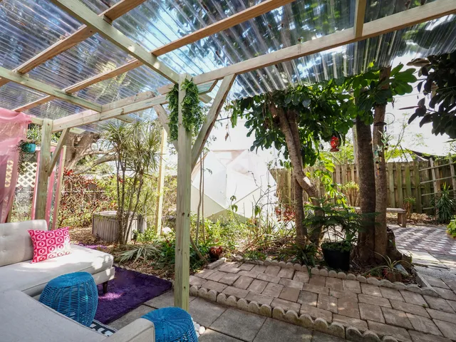 a view of a patio with table and chairs and potted plants