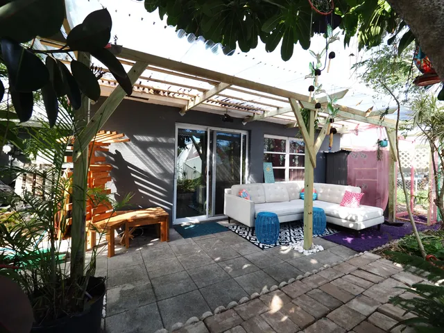 a building outdoor space with patio furniture and potted plants