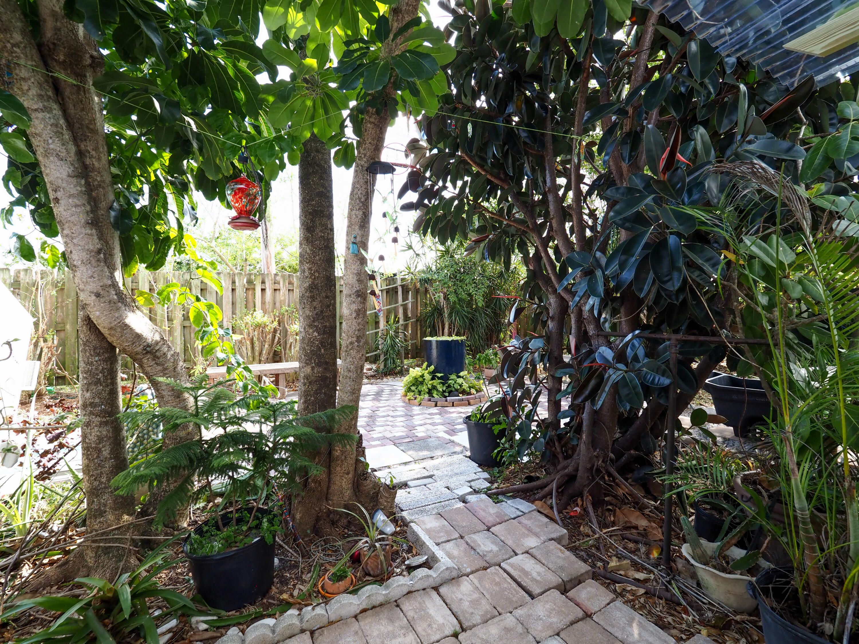 3664 Gull Road Palm Beach Gardens, FL 33410 - Photo 29 of 30 a tree lined with flowers in a garden