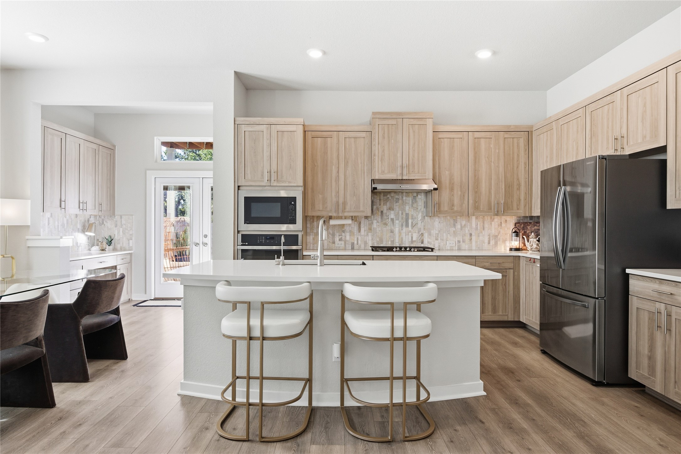 1008 Summer Glen Georgetown, TX 78628 - Photo 2 of 34 a kitchen with stainless steel appliances a refrigerator a stove a sink dishwasher and white cabinets with wooden floor